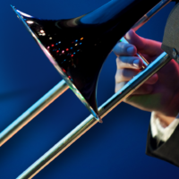 Promotional poster with the hand and trombone of a musician in front of a blue background.